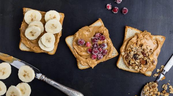pieces of bread with slices of bananas and peanut butter and granola