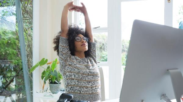 woman taking break from work to stretch