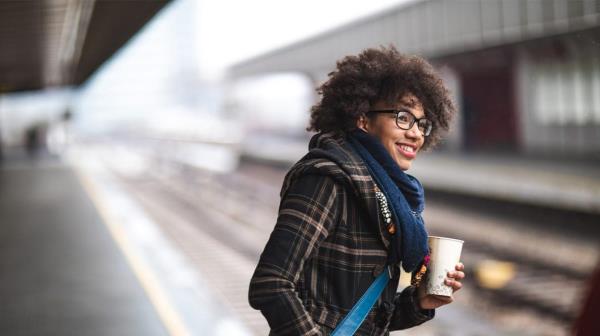 woman commuting to work holding coffee