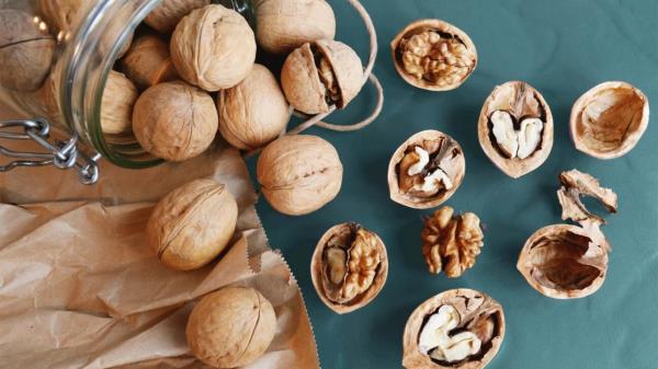 More than a dozen walnuts on a table