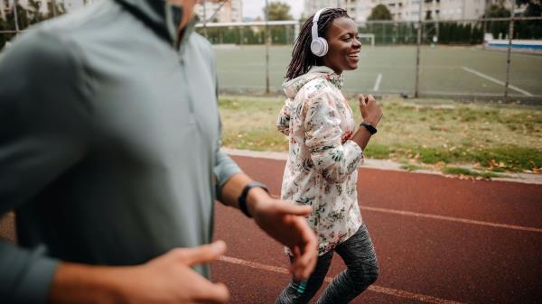 A happy woman jogging.